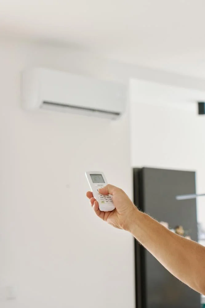 HVAC Installation Irvine 6 vecteezy hand holding remote control to set temperature on air 67967229 460